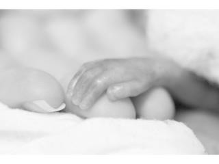 Aidan's tiny hand resting beside his foot